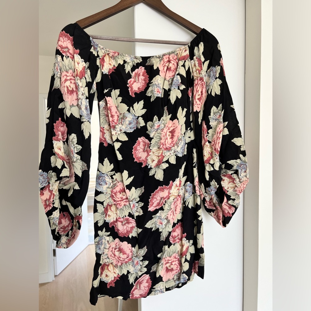 Off shoulder, black floral Reformation dress.